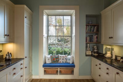 view of kitchen showing window seat and recessed bookshelves